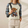 Deborah – Light Blue & Cream Jumper with Highland Cow Pattern