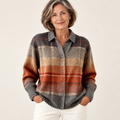 Mature British woman wearing the FLORIA blouse on a clean warm off-white studio background