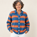 Mature British woman wearing the LIRENA blouse on a clean warm off-white studio background