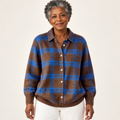 Mature British woman wearing the LIZZA blouse on a clean warm off-white studio background