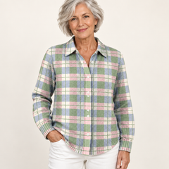 Mature British woman wearing the LENORA blouse on a clean warm off-white studio background