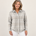 Mature British woman wearing the MONIRA blouse on a clean warm off-white studio background