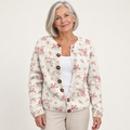 Evanthea | Knitted cardigan with tortoiseshell buttons and rose pattern worn by a mature woman on a clean background