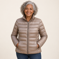 Ulla transitional padded jacket in Champagne worn by a mature woman, front view
