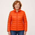 Ulla transitional padded jacket in Orange worn by a mature woman, front view
