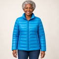 Ulla transitional padded jacket in Sky Blue worn by a mature woman, front view